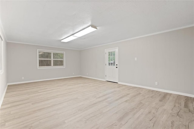 empty room featuring light hardwood / wood-style floors and crown molding