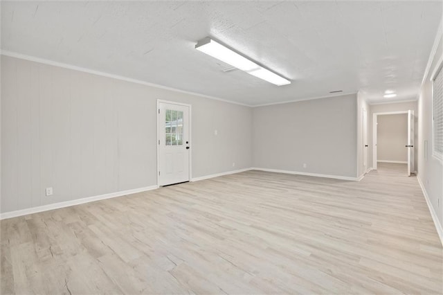 unfurnished room featuring ornamental molding and light wood-type flooring