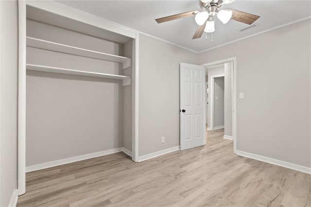 unfurnished bedroom with ceiling fan, a closet, ornamental molding, and light hardwood / wood-style flooring