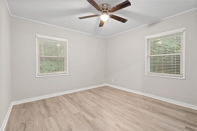 spare room featuring light wood-type flooring, ceiling fan, and crown molding