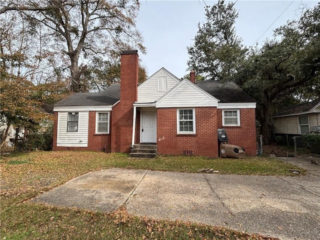 view of front of house with a patio area and a front yard