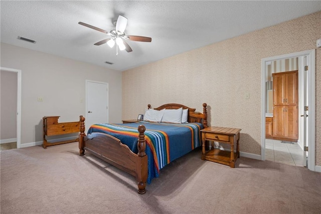 bedroom with a textured ceiling, ceiling fan, and carpet