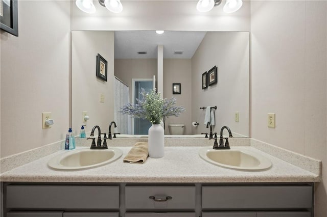 bathroom featuring vanity and toilet