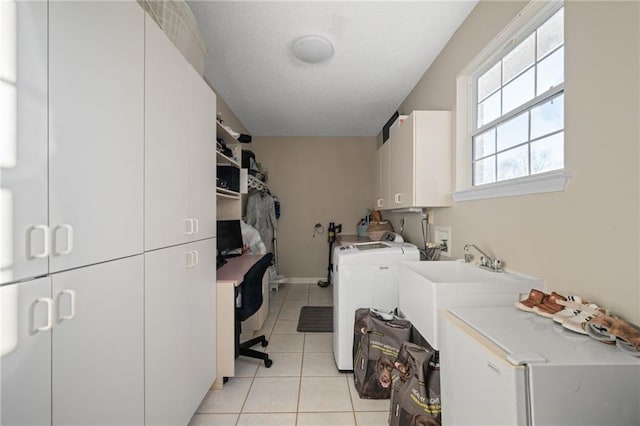 washroom with washer and clothes dryer, light tile patterned floors, and cabinets