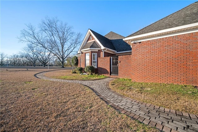 view of side of property with a lawn