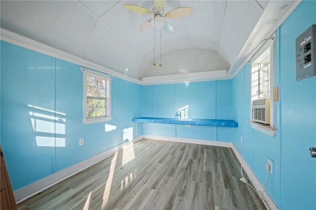 empty room featuring lofted ceiling, cooling unit, hardwood / wood-style floors, and ceiling fan