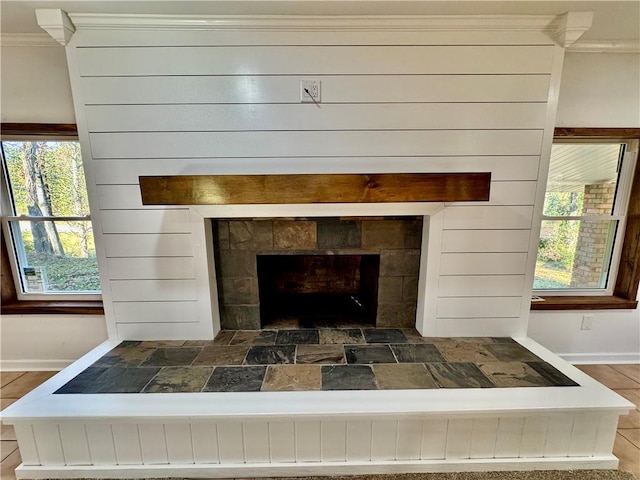 details with a stone fireplace and crown molding