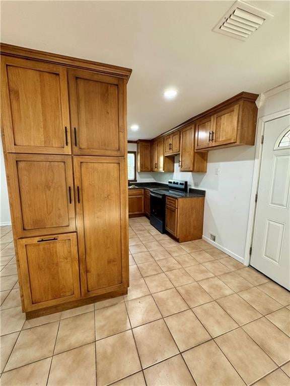 kitchen featuring electric range and light tile patterned flooring