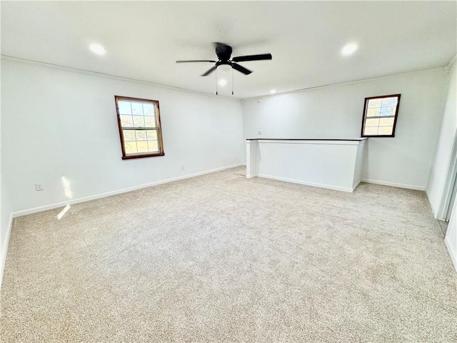 empty room featuring light carpet and ceiling fan