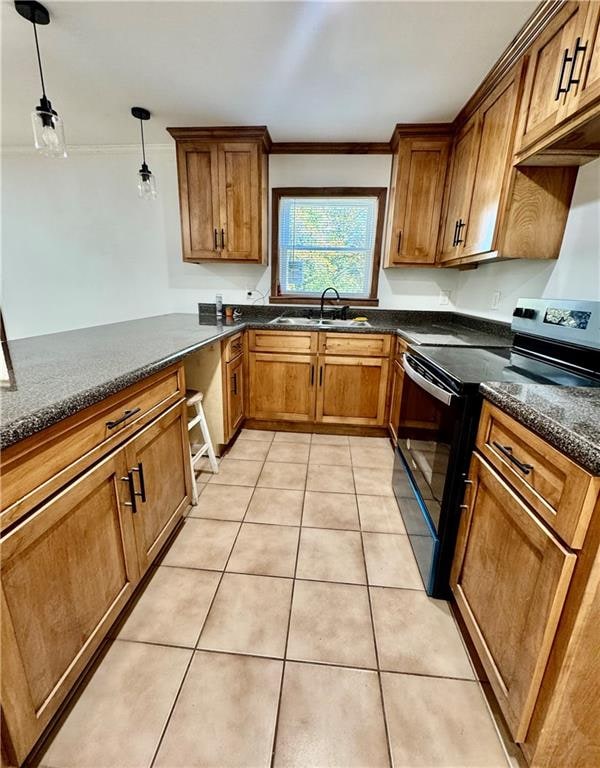 kitchen featuring pendant lighting, black range with electric stovetop, sink, and light tile patterned floors