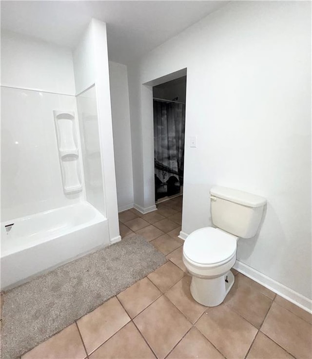 bathroom featuring tile patterned floors, shower / washtub combination, and toilet