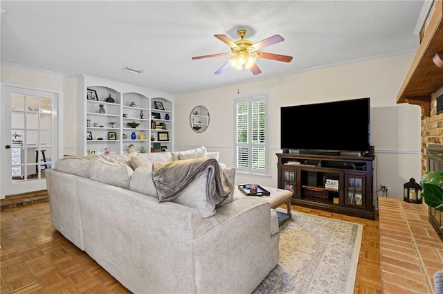 living area with a ceiling fan and a textured ceiling