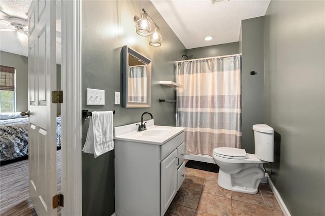 full bathroom with baseboards, connected bathroom, toilet, curtained shower, and vanity