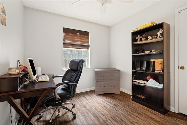 office space with a ceiling fan, baseboards, and wood finished floors