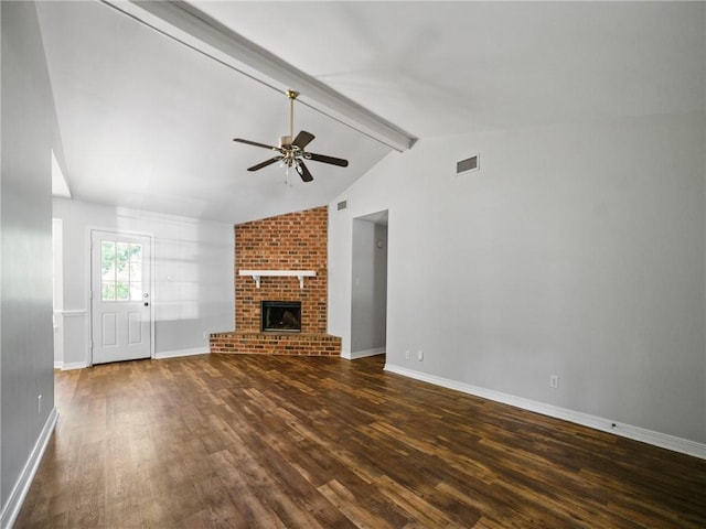 unfurnished living room featuring dark wood-type flooring, ceiling fan, vaulted ceiling with beams, and a brick fireplace