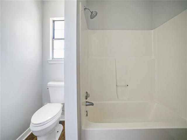 bathroom featuring toilet and  shower combination