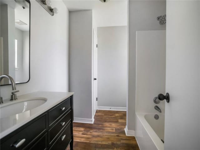 bathroom featuring shower / bath combination, hardwood / wood-style flooring, and vanity