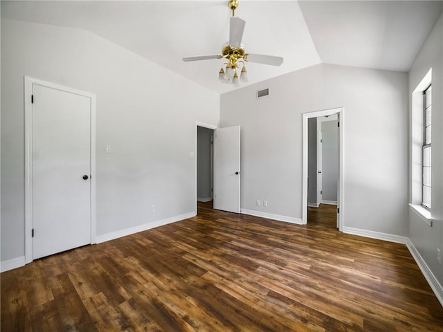 unfurnished bedroom featuring ceiling fan, dark hardwood / wood-style flooring, and vaulted ceiling