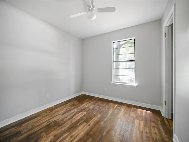 empty room with ceiling fan and dark hardwood / wood-style flooring