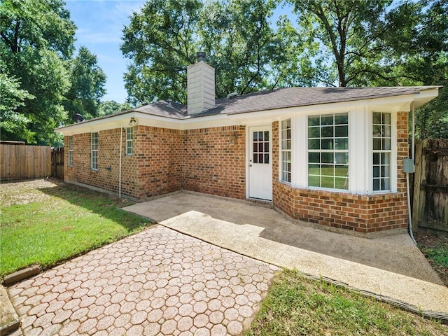 back of house featuring a yard and a patio area