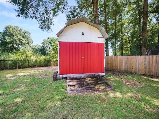 view of outbuilding with a yard