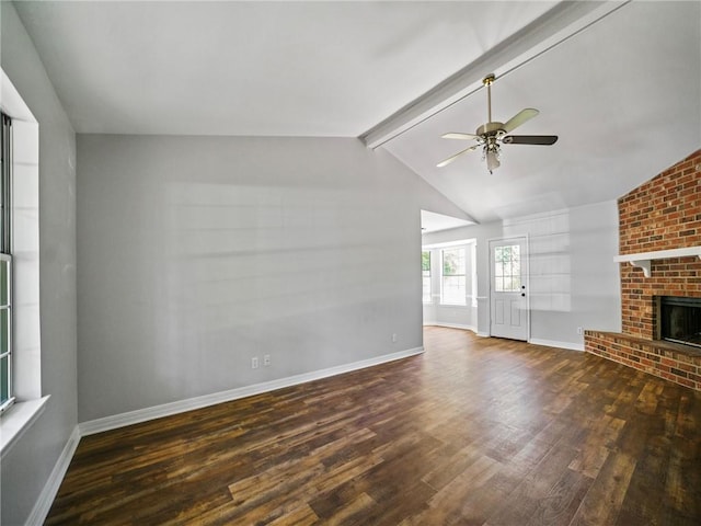 unfurnished living room with dark wood-type flooring, ceiling fan, a brick fireplace, and vaulted ceiling with beams