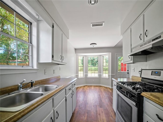 kitchen with a wealth of natural light, sink, stainless steel gas range oven, and white cabinets