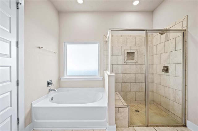 bathroom featuring tile patterned floors and plus walk in shower