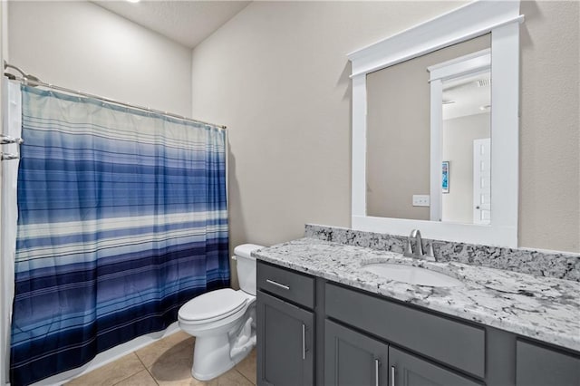 bathroom featuring toilet, tile patterned flooring, a textured ceiling, vanity, and curtained shower