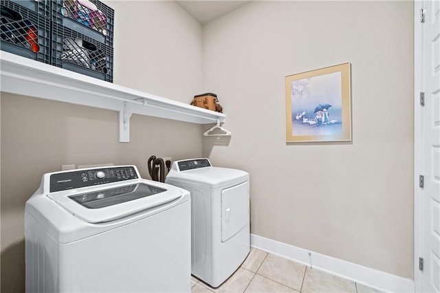 laundry room featuring light tile patterned floors and independent washer and dryer