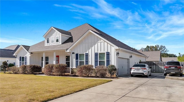 view of front of property featuring a front lawn and a garage