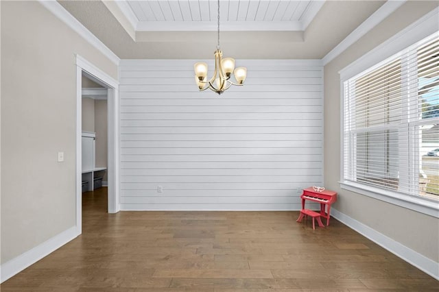 dining room with plenty of natural light, a tray ceiling, dark hardwood / wood-style flooring, and a notable chandelier