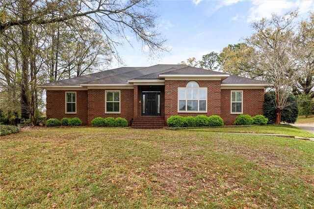 ranch-style home with brick siding and a front lawn