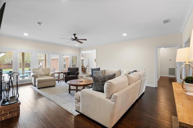 living area with a ceiling fan, dark wood-style floors, and visible vents