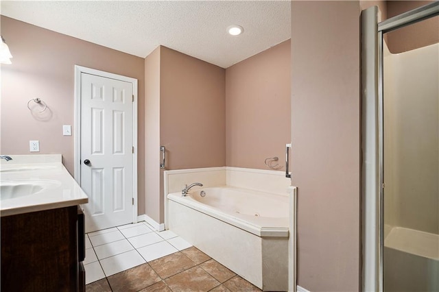 bathroom with vanity, a textured ceiling, separate shower and tub, and tile patterned flooring