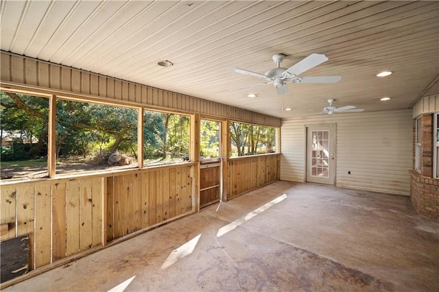 unfurnished sunroom featuring ceiling fan