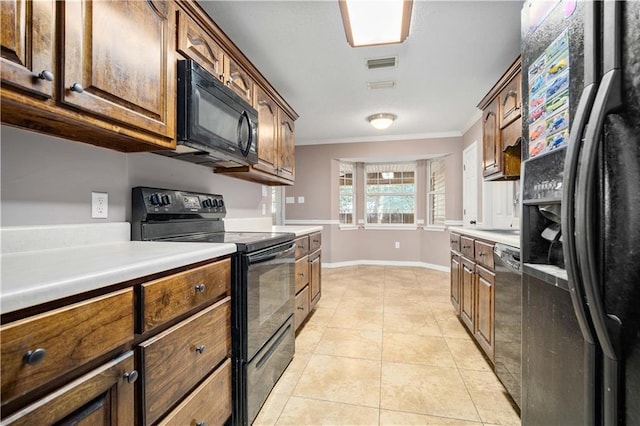 kitchen featuring light tile patterned floors, black appliances, and ornamental molding