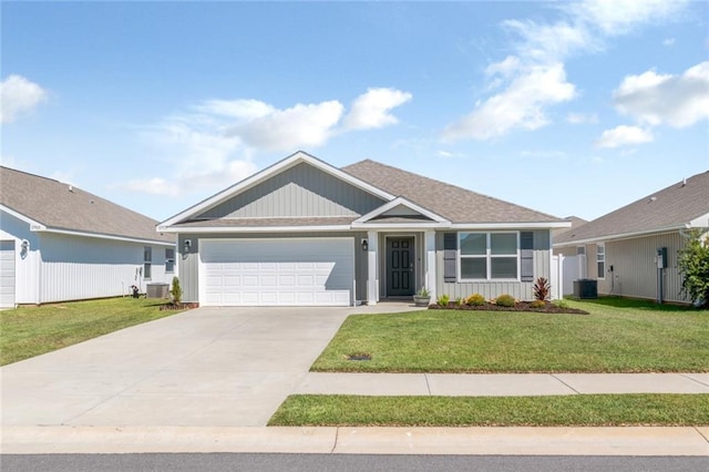 view of front of property featuring a front lawn, central AC, and a garage