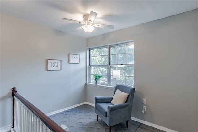 sitting room featuring ceiling fan