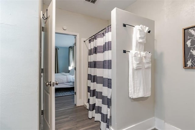 bathroom featuring a shower with curtain and hardwood / wood-style floors