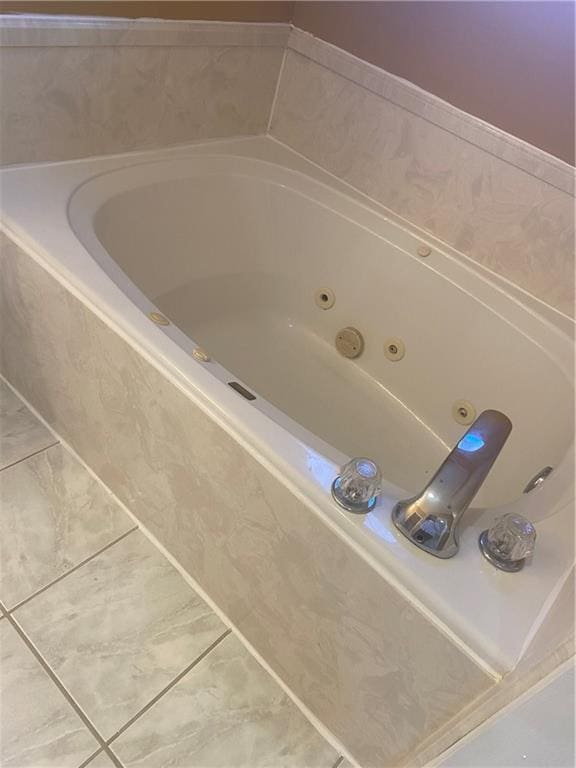 bathroom featuring tile patterned flooring and a relaxing tiled tub