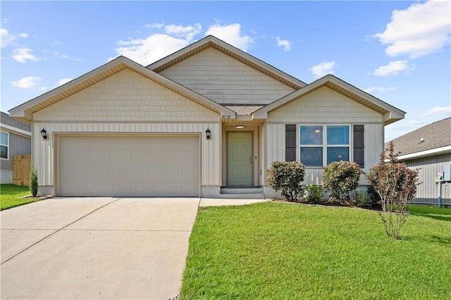 10520 Wales Ln, Spanish Fort, AL 36527 - view of front of property with an attached garage, concrete driveway, and a front lawn