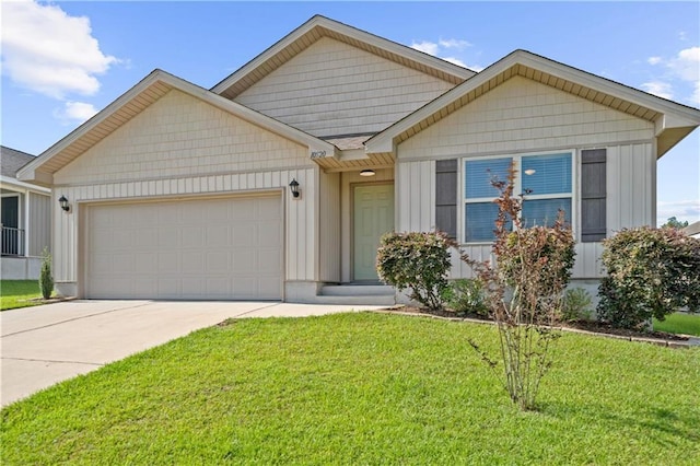 10520 Wales Ln, Spanish Fort, AL 36527 - view of front of property featuring a garage, concrete driveway, a front yard, and board and batten siding