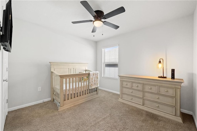 10520 Wales Ln, Spanish Fort, AL 36527 - carpeted bedroom with baseboards, a crib, and a ceiling fan