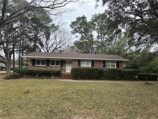 ranch-style house with brick siding and a front yard