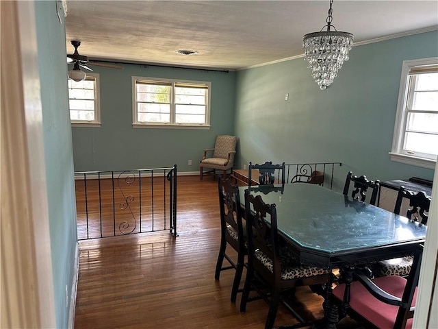 dining area with ornamental molding, wood finished floors, and a wealth of natural light