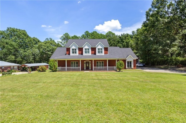 cape cod home with covered porch and a front lawn