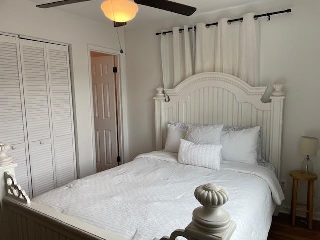 bedroom with ceiling fan, dark hardwood / wood-style floors, and a closet