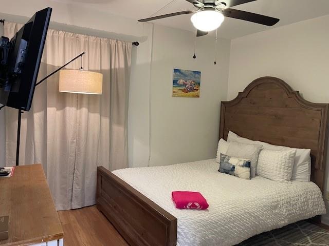 bedroom featuring hardwood / wood-style floors and ceiling fan