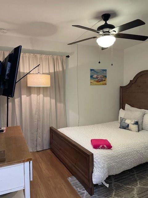 bedroom featuring hardwood / wood-style flooring and ceiling fan